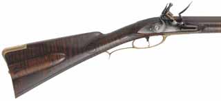 Colonial Longrifle,
.54 caliber, 43-1/2" swamped barrel, 
round faced flintlock, curly maple, engraved brass,
light patina finish, signed by Mike Compton