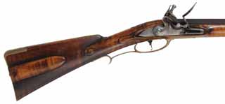 Colonial Longrifle,
.58 caliber, 43-1/2" swamped barrel, 
round faced flintlock, curly maple, 
used, signed by Mike Compton