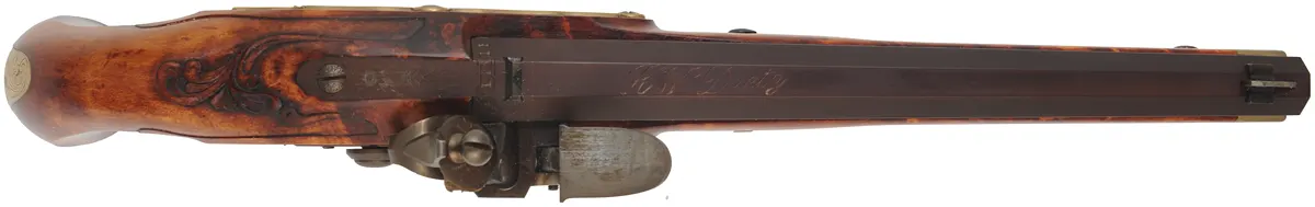 Kentucky Pistol
.50 caliber 10-1/2" tapered barrel,
small Siler flint lock, curly maple,
engraved brass trim, signed by R.W. Deitz Kentucky Pistol
.50 caliber 10-1/2" tapered barrel,
small Siler flint lock, curly maple,
engraved brass trim, signed by R.W. Deitz