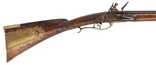 Bucks County Longrifle,
.45 caliber, 43-1/2" octagon barrel,
R. Gale flintlock, curly maple, brass with side opening patchbox,
used, signed R.E. Grieder