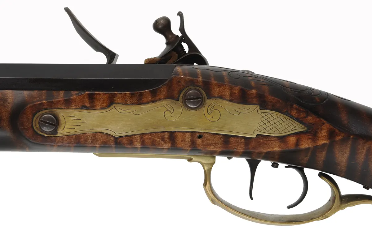Golden Age Longrifle,
.45 caliber,  42" Colerain swamped barrel, 
curly maple, engraved brass patchbox, 
double set triggers, large Siler lock, unsigned, 
