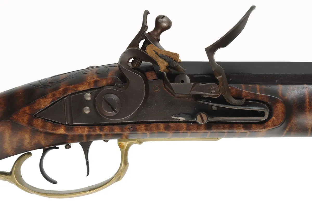 Golden Age Longrifle,
.45 caliber,  42" Colerain swamped barrel, 
curly maple, engraved brass patchbox, 
double set triggers, large Siler lock, unsigned, 
