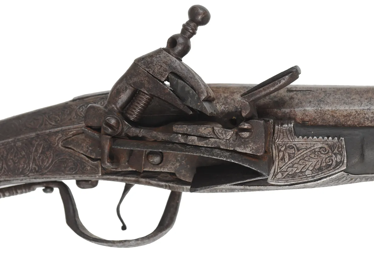 Antique Miquelet Musket, 
.60 caliber smoothbore, 54-1/2" barrel,
Miquelet flintlock, engraved steel & brass trim