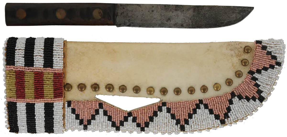 Knife with Beaded Knife Sheath,
6" blade, walnut scales,
11-1/2" long by 3-3/4" wide,
leather and rawhide, brass tacks