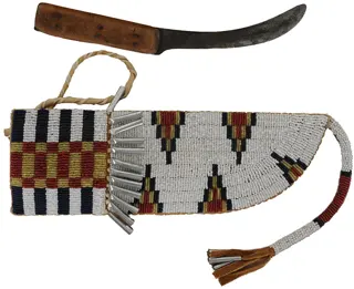 Knife with Beaded Knife Sheath,
5" blade, maple scales,
10-1/2" long by 3-1/2" wide,
leather and rawhide, tin cones