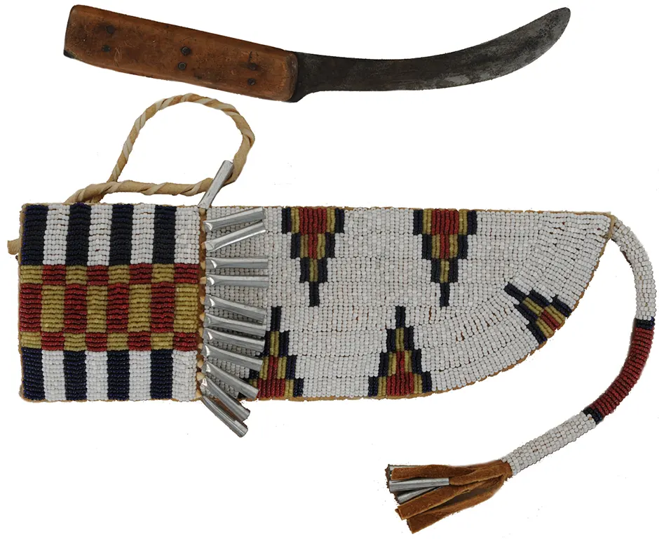 Knife with Beaded Knife Sheath,
5" blade, maple scales,
10-1/2" long by 3-1/2" wide,
leather and rawhide, tin cones