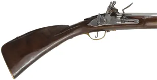 Doglock Trade Musket,
.69 caliber smoothbore, 51-1/2" octagon-to-round barrel,
teak stained as walnut, brass trim, lock marked I. Cookson,
used, made in India