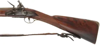 Left Hand New England Fowler, 
20 gauge turkey choke, 38" octagon to round barrel,
L&R Queen Anne flintlock, checkered cherry, brass 
used, marked B. Barrows